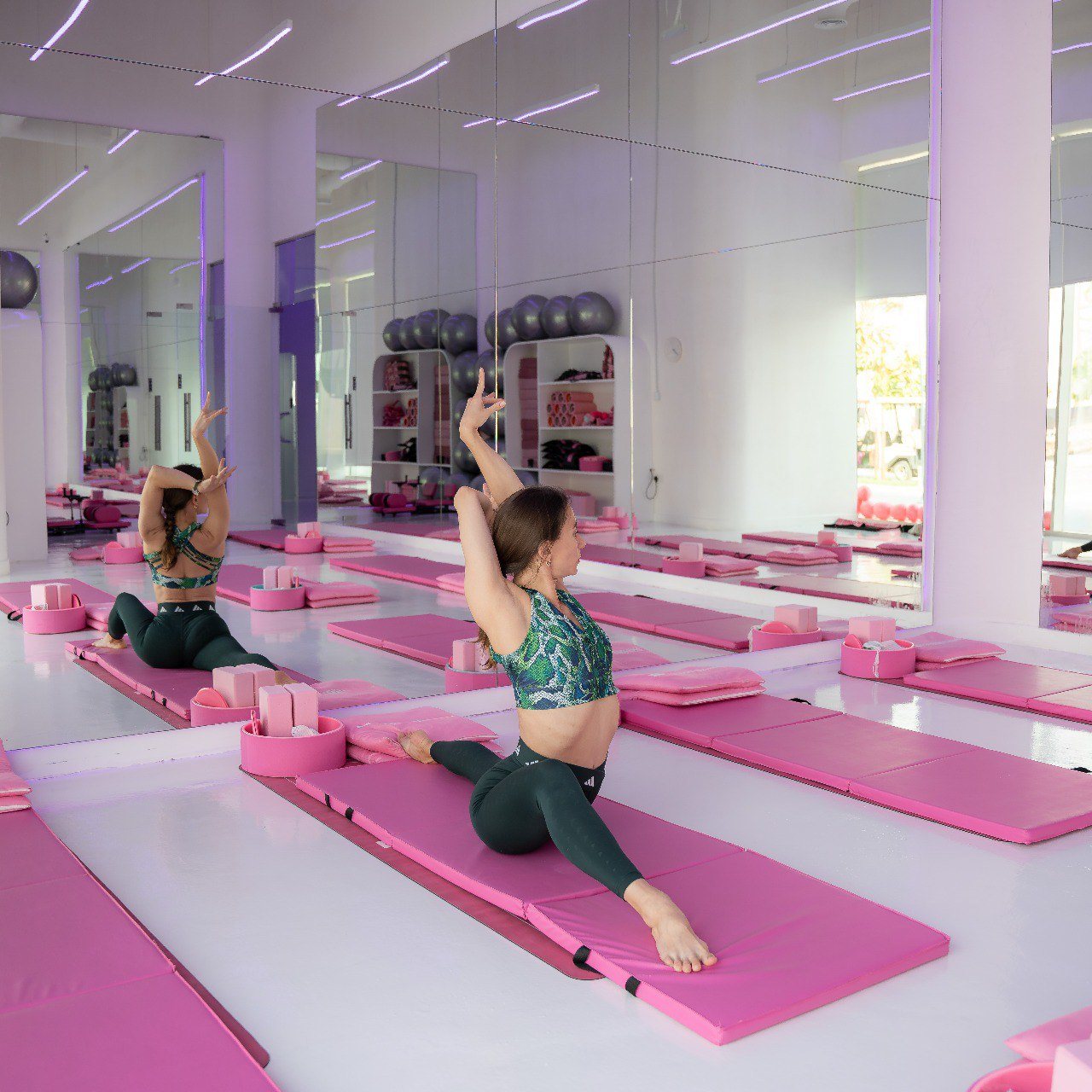 Radmila Aitova practising in a mirrored studio during a group class